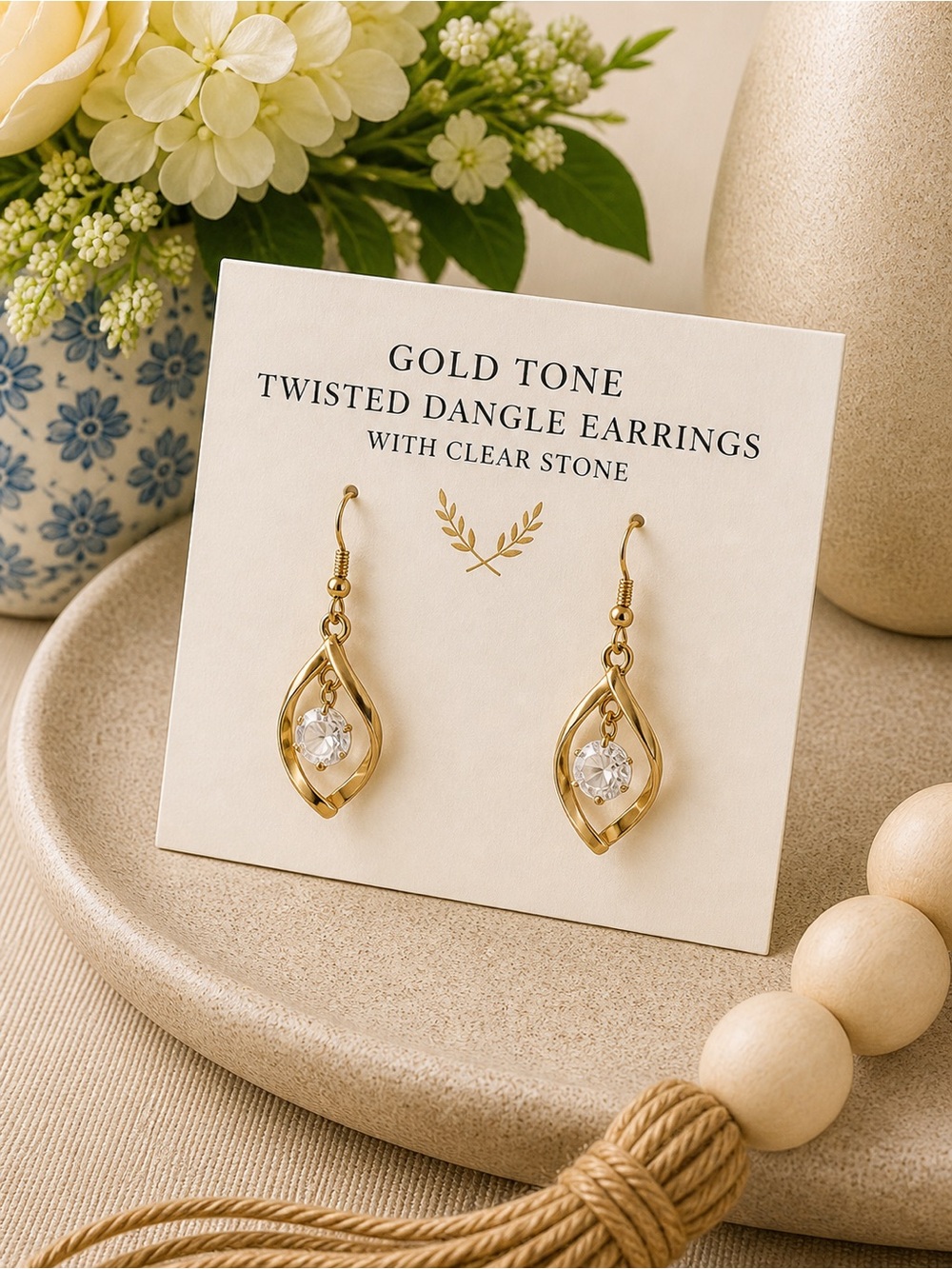 Gold Tone Twisted Dangle Earrings With Clear Stone